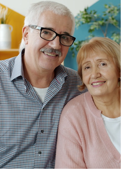 A retired couple smiling together at home