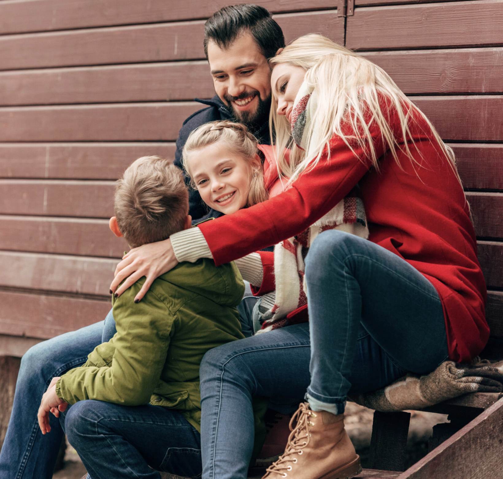 A family standing together outdoors among the trees